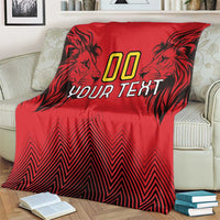 Red rugby blanket with lion head graphics, “00 YOUR TEXT” design, and zigzag pattern