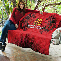 Red quilt blanket draped on sofa with black palm graphics, gold “00” and “YOUR TEXT”