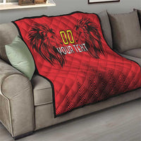 Red custom quilt blanket on gray couch with black design, gold “00” and “YOUR TEXT”