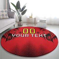 Round red rug featuring '00' above 'YOUR TEXT' with black leaf motifs and zigzag stripes