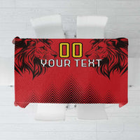 Red tablecloth with black lion heads, geometric zigzags, and bold '00 YOUR TEXT' print.