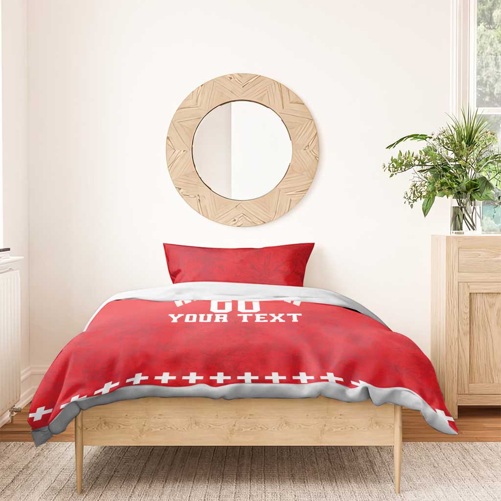 Red duvet cover set on bed with two pillows; white “DO YOUR TEXT” and rugby cross trim.