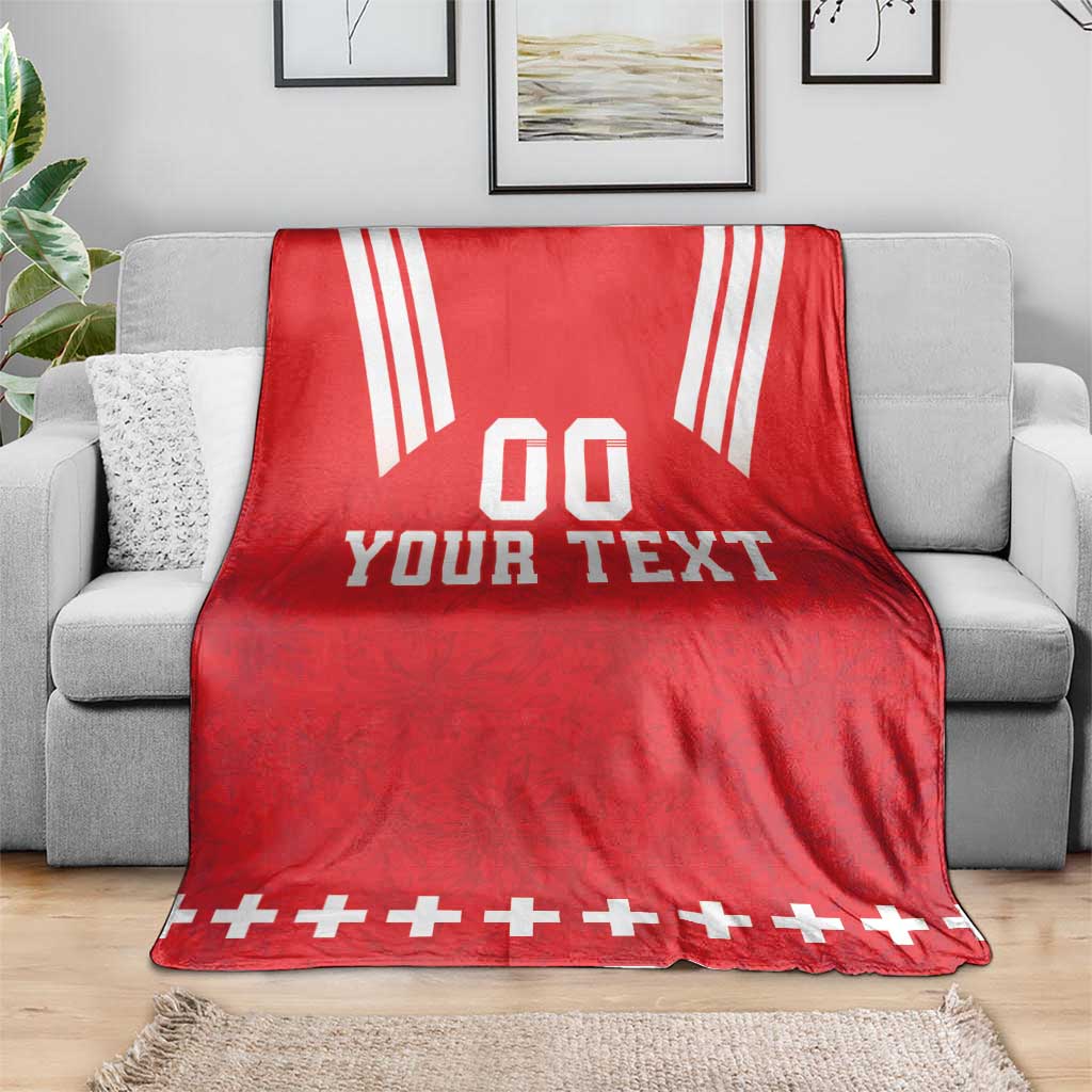 Red rugby blanket on sofa with white stripes and 'YOUR TEXT' center