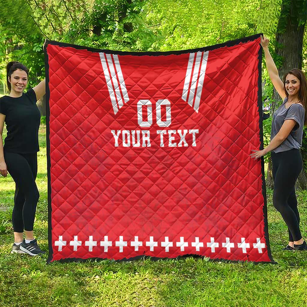 Red quilt blanket with white V stripes, “00” and “YOUR TEXT,” plus sign border along edge