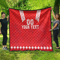 Red quilt blanket with white V stripes, “00” and “YOUR TEXT,” plus sign border along edge