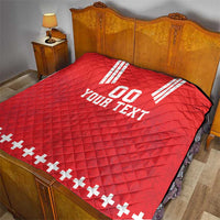 Red quilt blanket on bed with white V stripes, “00,” “YOUR TEXT,” and plus sign trim