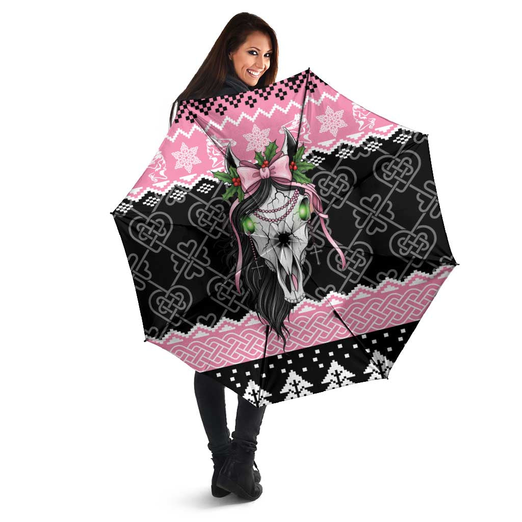 Pink and black umbrella with Mari Lwyd skull, Celtic knots, held open by a person
