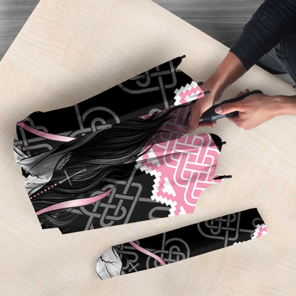 Folded umbrella showing black and pink Mari Lwyd skull graphic with Celtic knot trim