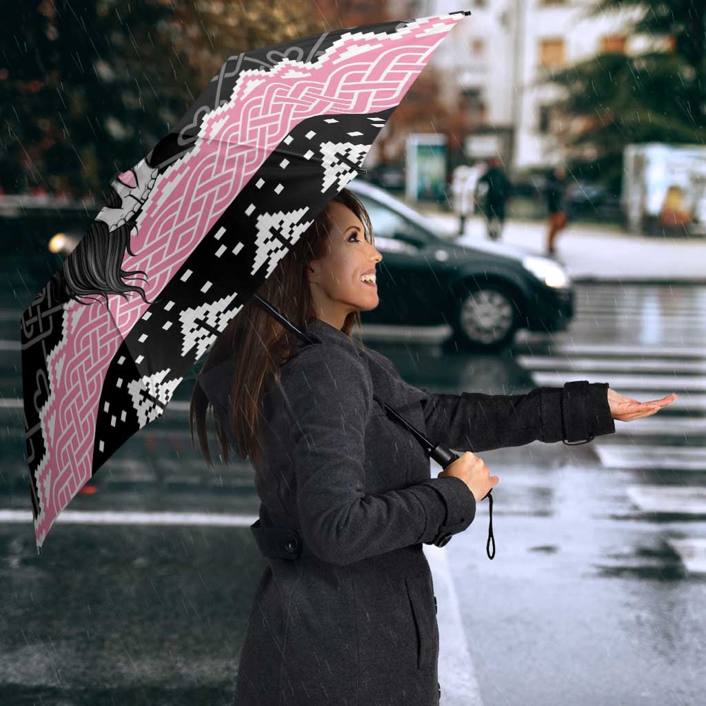 Pink and black umbrella with Mari Lwyd skull and Celtic knot pattern, seen from side angle