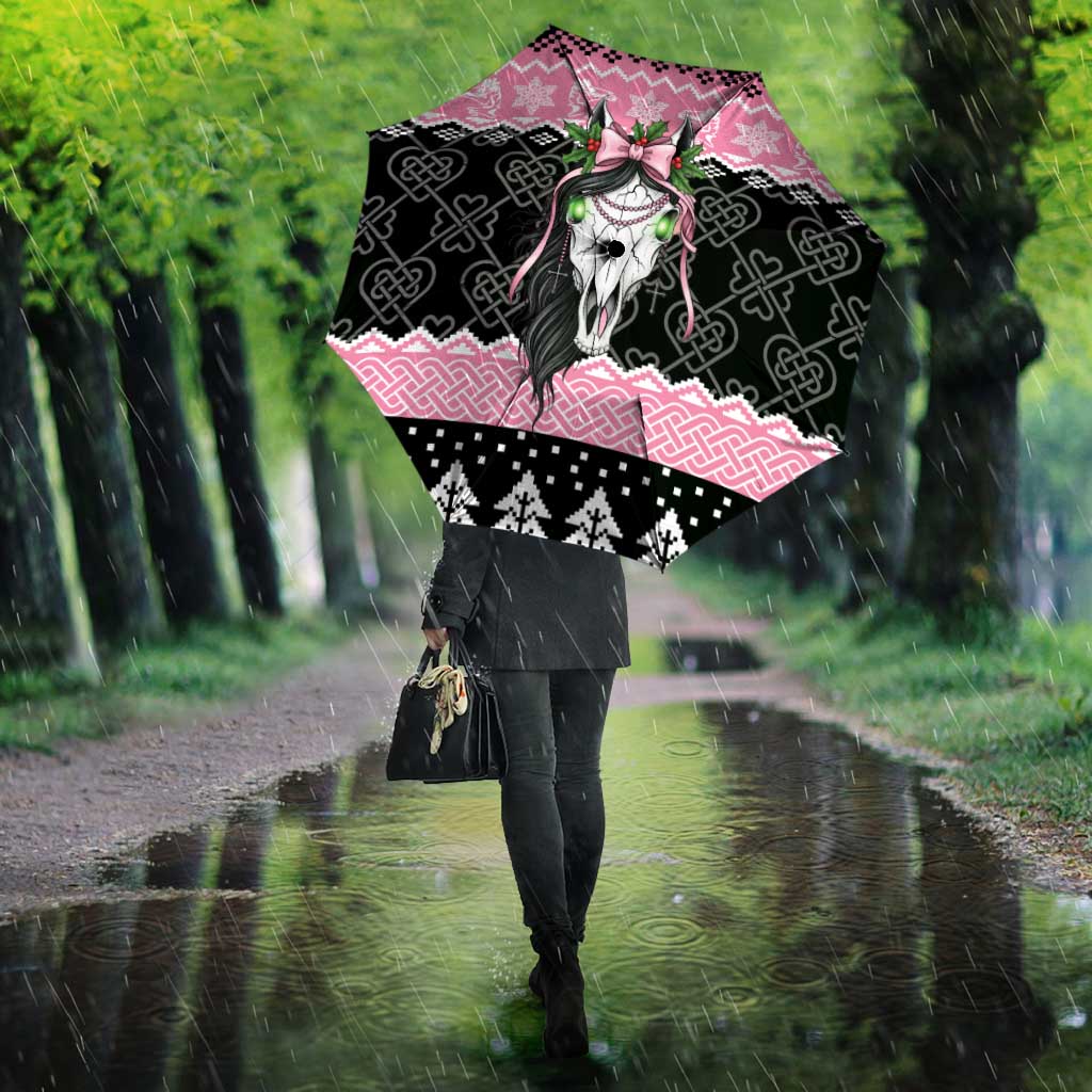 Pink and black umbrella with Mari Lwyd skull and Celtic knots, front view