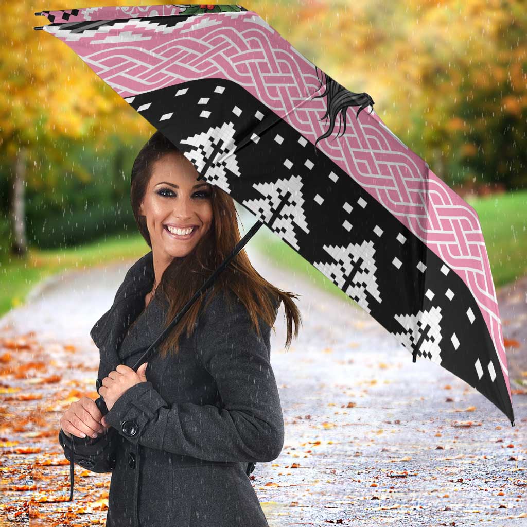 Pink and black umbrella with Mari Lwyd skull and Celtic knot design, open and angled