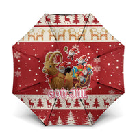 Red Christmas umbrella with Nordic God Jul lettering, reindeer, trees, and snowflakes