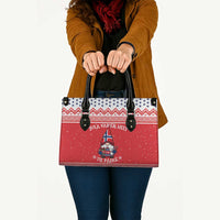 Red printed tote bag with black handles and buttoned leather-look straps