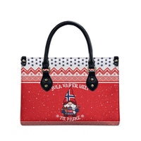 Red printed tote bag with black top handles and gnome decoration on the front