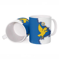 Ceramic mug from side, blue flag panel with yellow eagle, white interior visible