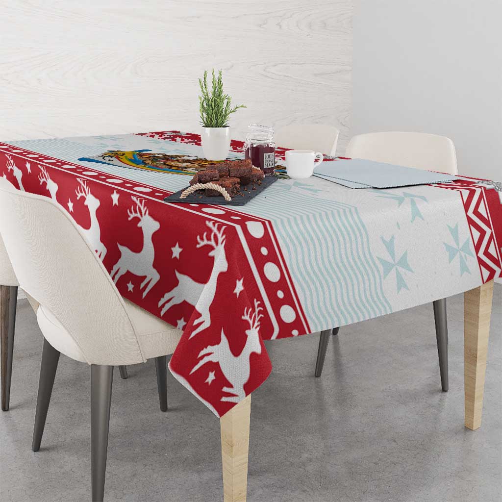 Red Christmas tablecloth with white reindeer, stars, and blue striped sections on a table