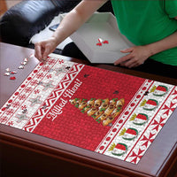 Christmas jigsaw puzzle board with red tree scene and assembling pieces on table