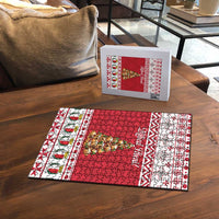 Christmas jigsaw puzzle set with box and red and white puzzle board on table