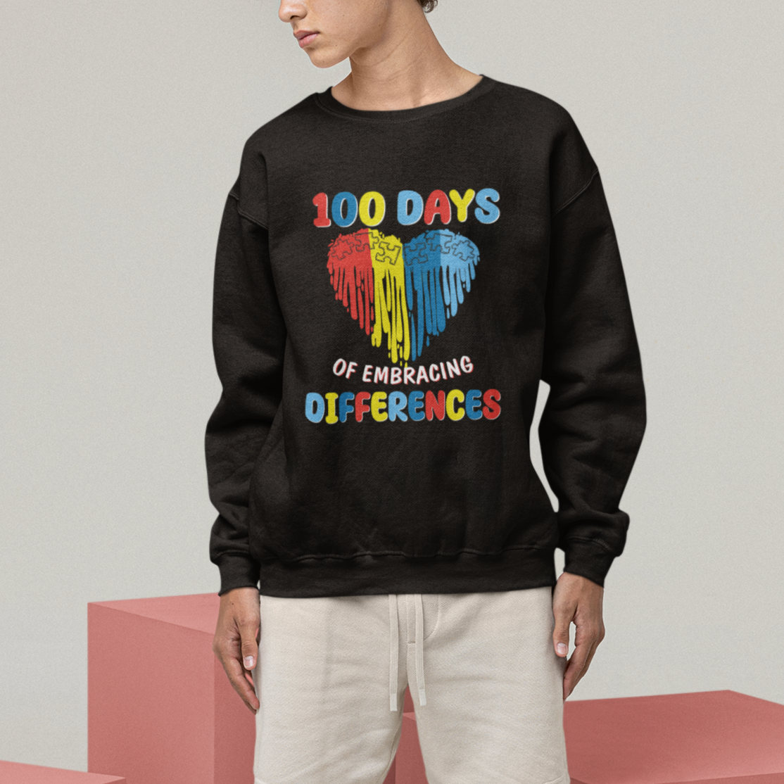 Black sweatshirt with colorful heart graphic reading "100 DAYS OF EMBRACING DIFFERENCES"