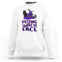 White sweatshirt with centered purple witch cat illustration and "resting witch face" design