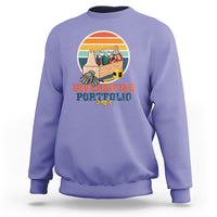 Purple crewneck sweatshirt with “Diversified Portfolio” tools graphic on chest
