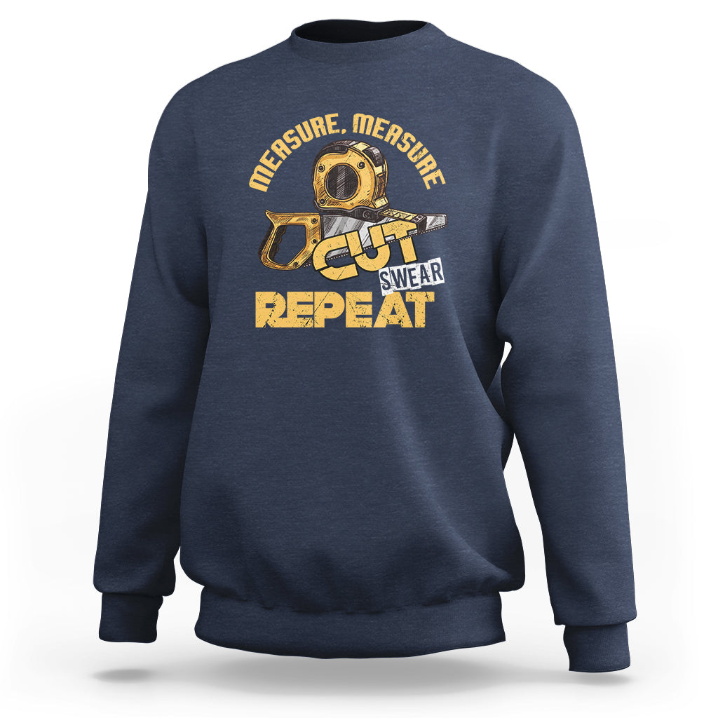 Navy woodworker sweatshirt with tape-measure graphic: CUT SWEAR REPEAT