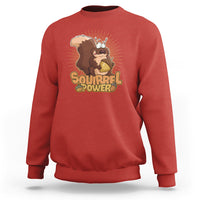 Red sweatshirt with 'Squirrel Power' squirrel graphic, crew neck, long sleeves.