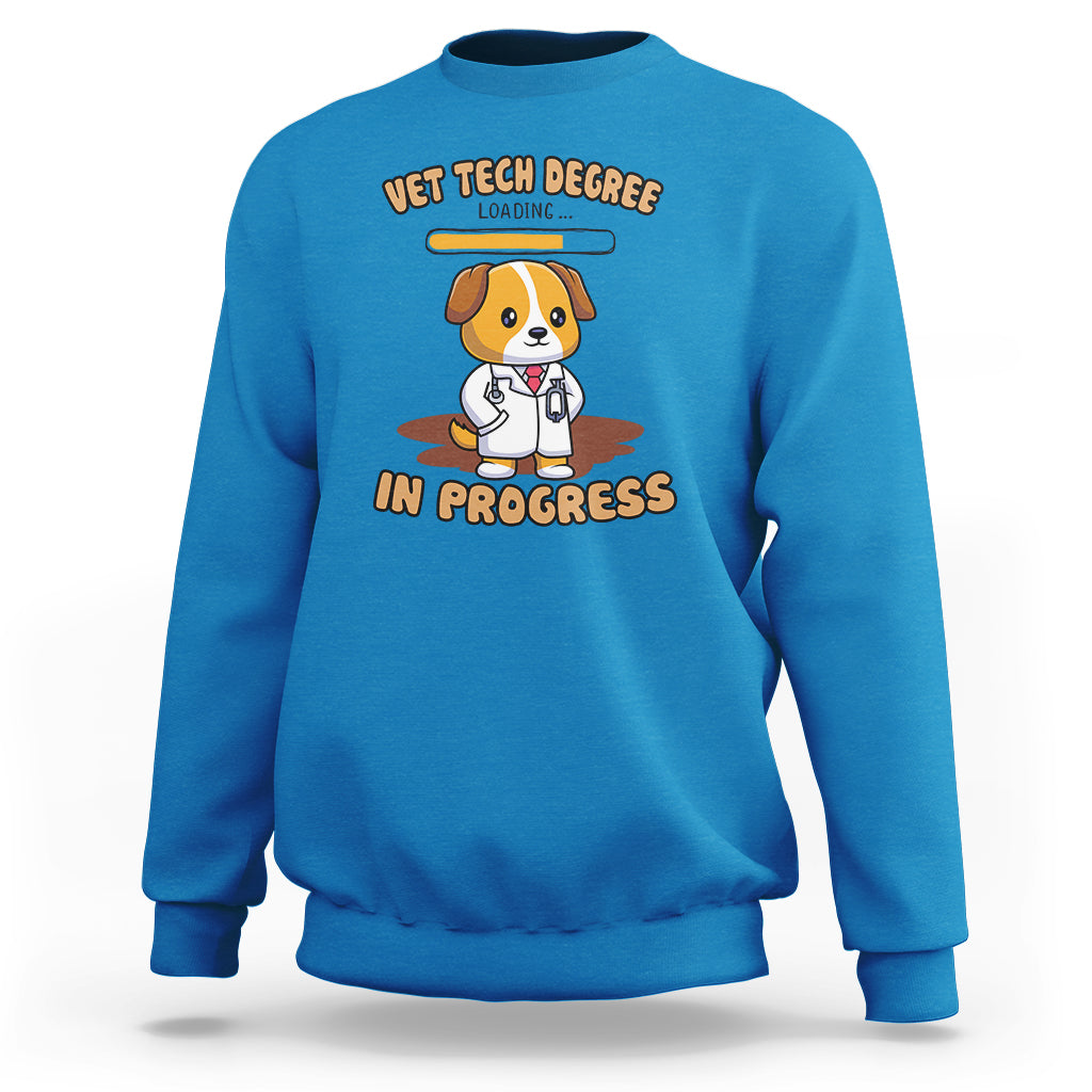 Blue vet tech degree sweatshirt with cartoon dog and “in progress” graphic on chest