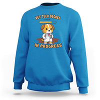 Blue vet tech degree sweatshirt with cartoon dog and “in progress” graphic on chest