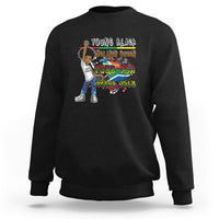 Black crewneck sweatshirt with colorful front graphic, long sleeves and ribbed cuffs.