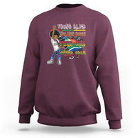 Maroon crewneck sweatshirt with colorful front graphic, long sleeves and ribbed cuffs.