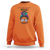 Orange mental health support sweatshirt with “STAY” text and messy bun awareness graphic