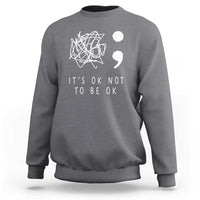 Dark heather gray crewneck sweatshirt with white “It’s OK not to be OK” message graphic on front
