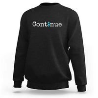Black crewneck sweatshirt with white “Continue” text and green semicolon graphic