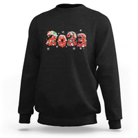 Black crewneck sweatshirt with colorful 2023 graphic and festive snowflake accents