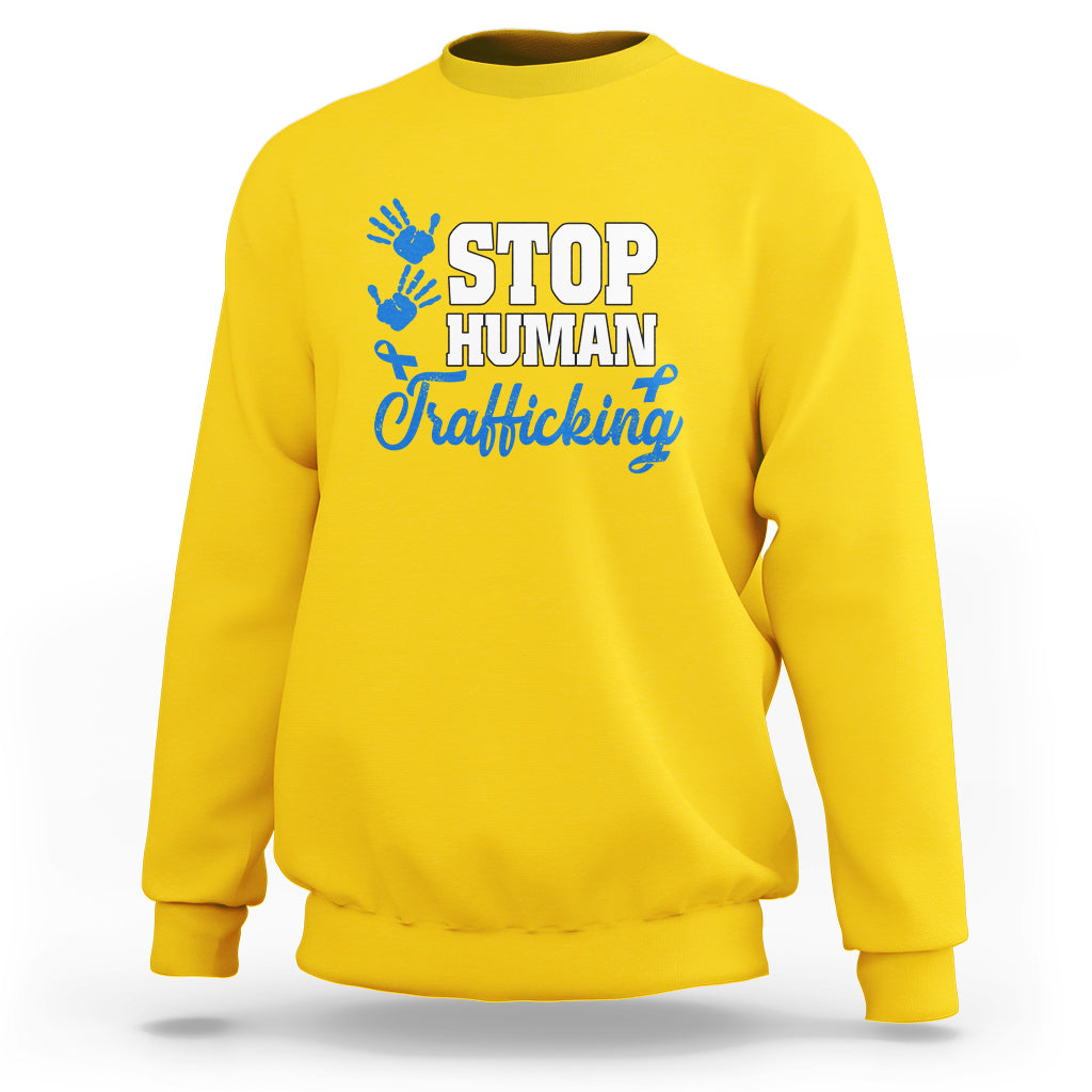Yellow sweatshirt with blue ribbon graphic and “STOP HUMAN Trafficking” text on front