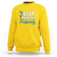 Yellow sweatshirt with blue ribbon graphic and “STOP HUMAN Trafficking” text on front