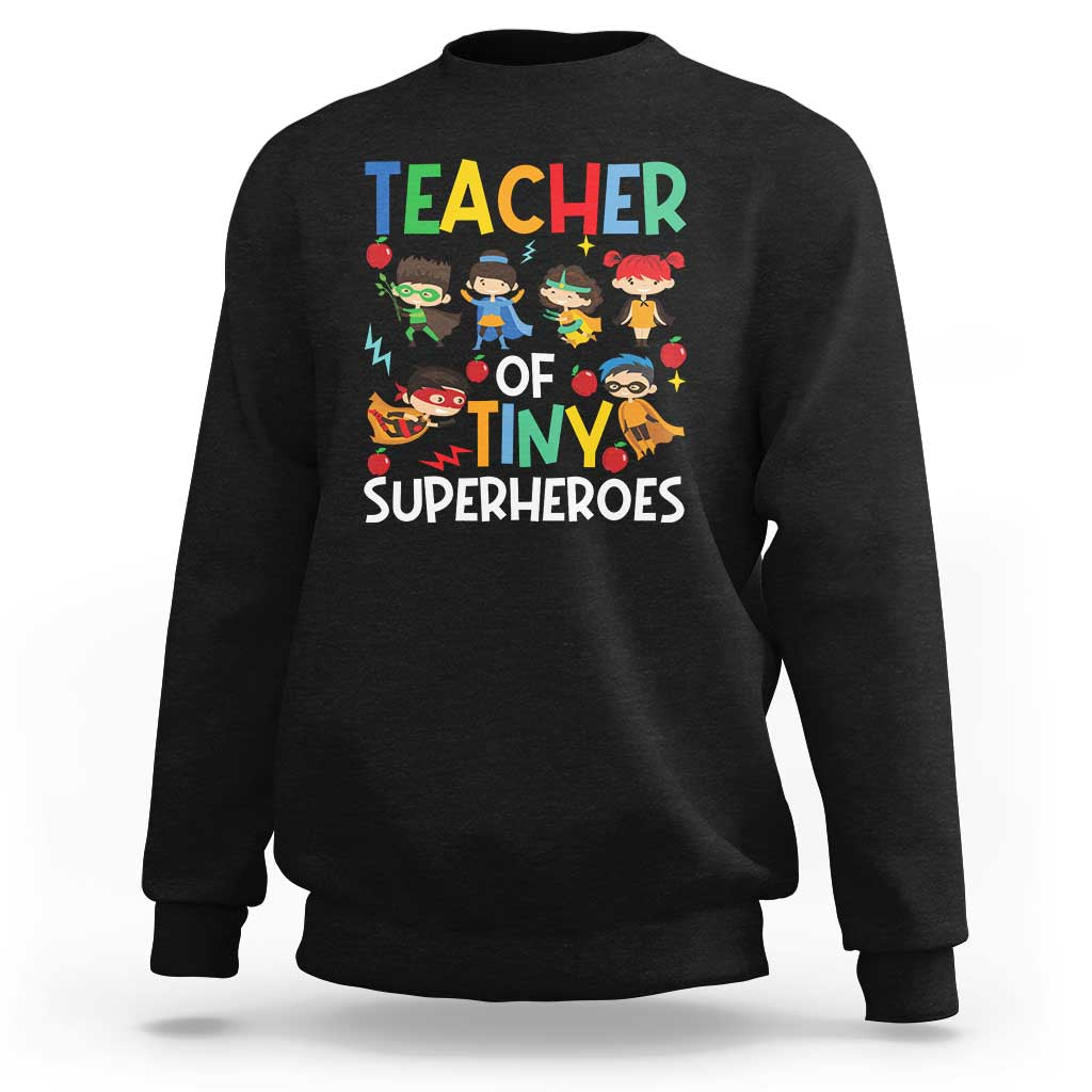 Black sweatshirt with “TEACHER OF TINY SUPERHEROES” superhero graphic on front