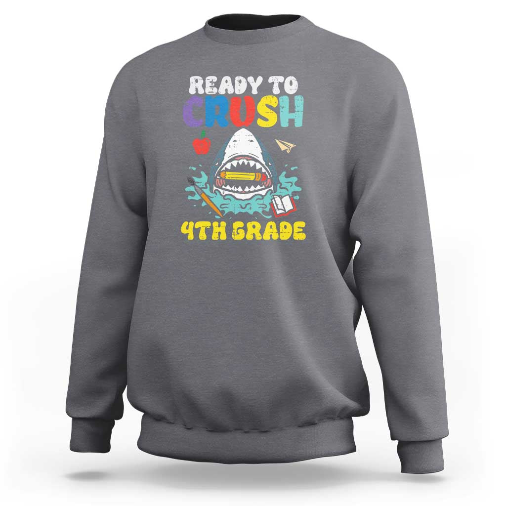 Gray crewneck sweatshirt with colorful shark graphic and long sleeves.