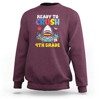 Maroon crewneck sweatshirt with colorful shark graphic and long sleeves.