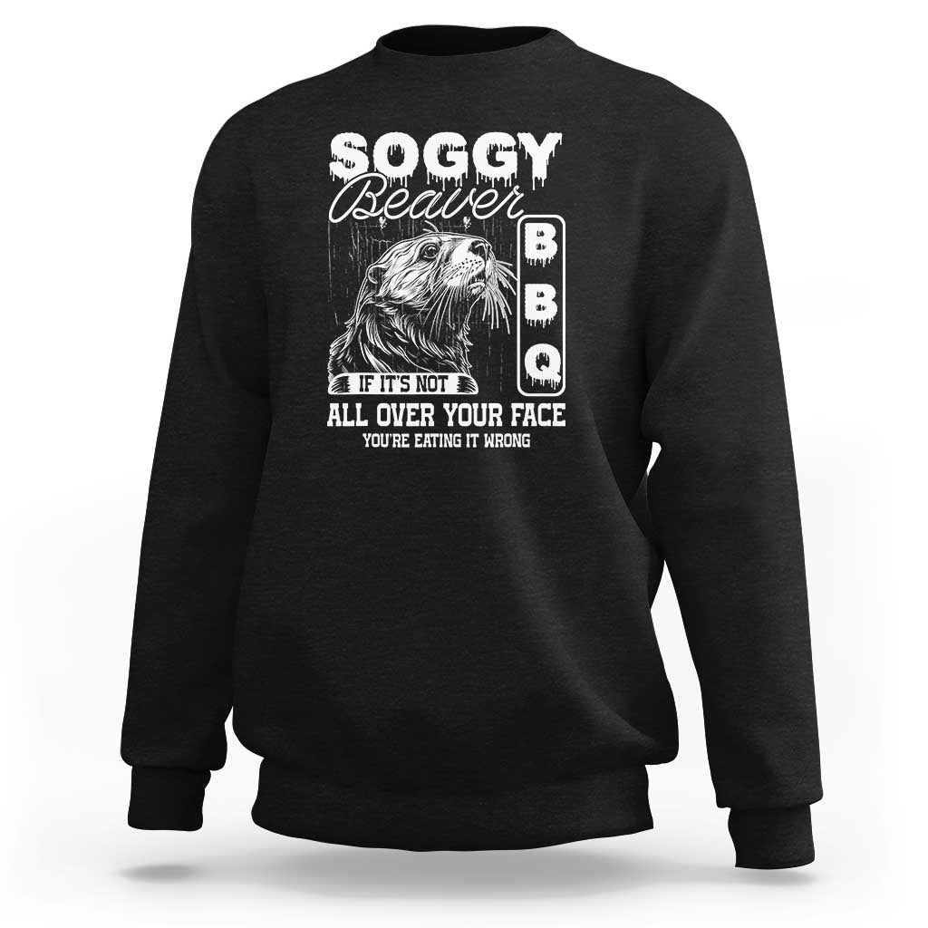 Black sweatshirt with 'Soggy Beaver' graphic and face-eating quote
