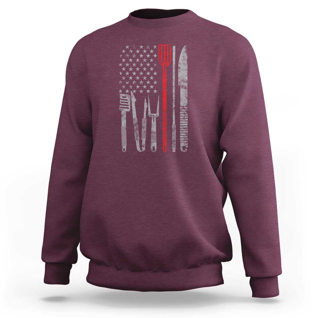 Maroon sweatshirt with American flag graphic and chef utensils printed on back