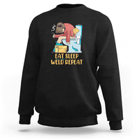 Black crewneck sweatshirt with welding graphic and “Eat Sleep Weld Repeat” text