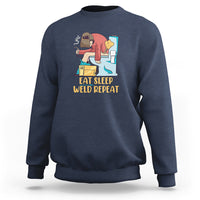 Navy crewneck sweatshirt with welding graphic and “Eat Sleep Weld Repeat” text