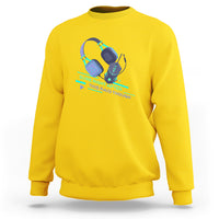 Daisy yellow crewneck sweatshirt with teal gaming controller raid graphic on front