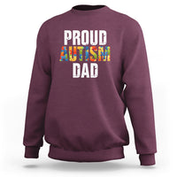 Maroon sweatshirt with front text “PROUD AUTISM DAD” and colorful puzzle graphic.
