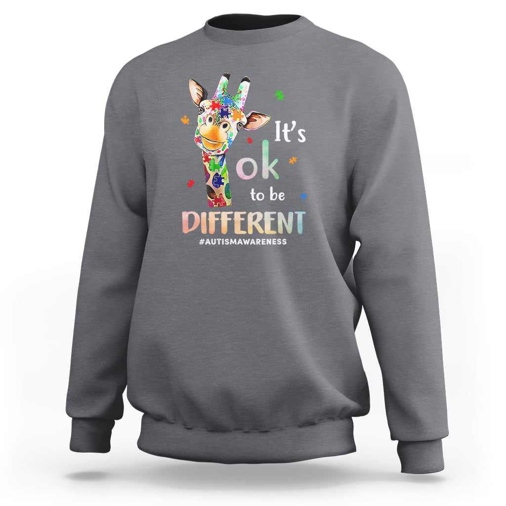 Gray crewneck sweatshirt with colorful giraffe graphic and “It’s ok to be different” print