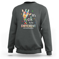 Charcoal gray crewneck sweatshirt with colorful giraffe graphic and “It’s ok to be different”