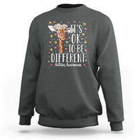 Charcoal gray autism awareness sweatshirt with giraffe floral graphic: 'It's OK to be different'