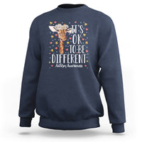 Navy blue autism awareness sweatshirt with giraffe floral graphic: 'It's OK to be different'